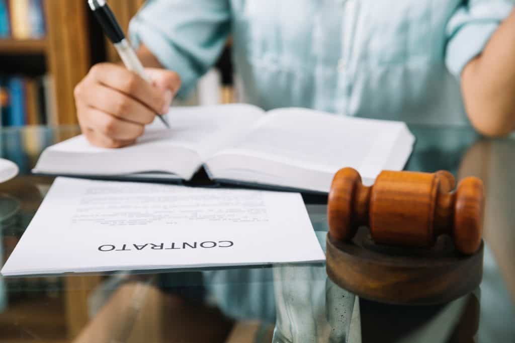 lawyer sitting with gavel contract book table